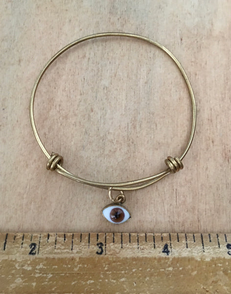 Adjustable brass bangle with brown eye dangle