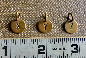 Brass letters X, Y, Z