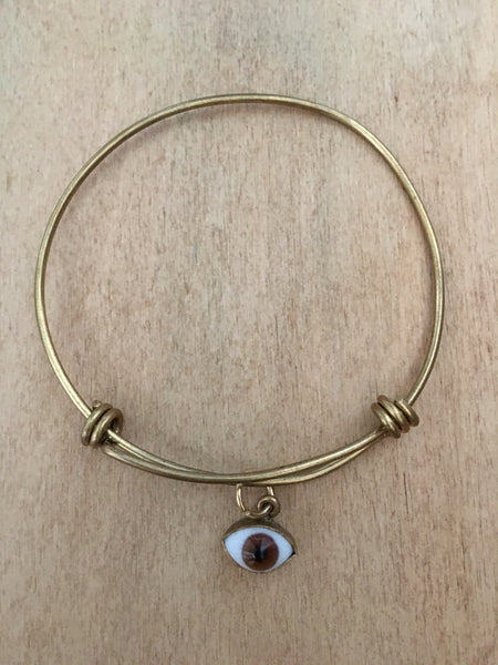 Adjustable brass bangle with brown eye dangle