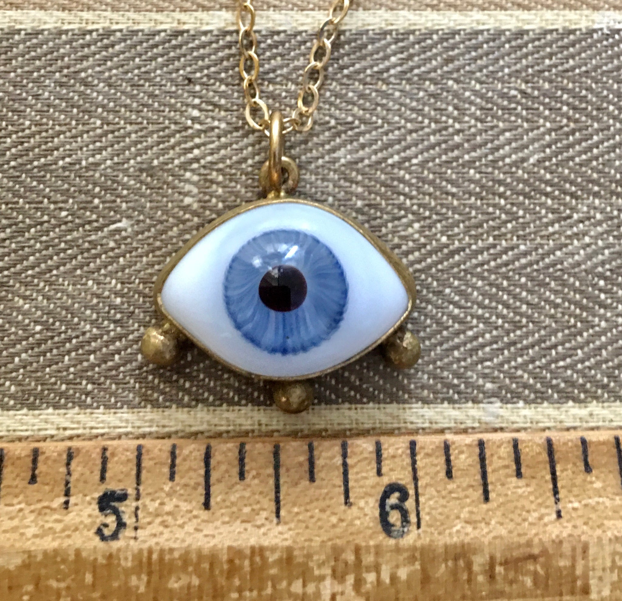 Blue eye charm with lashes on a 16” brass chain