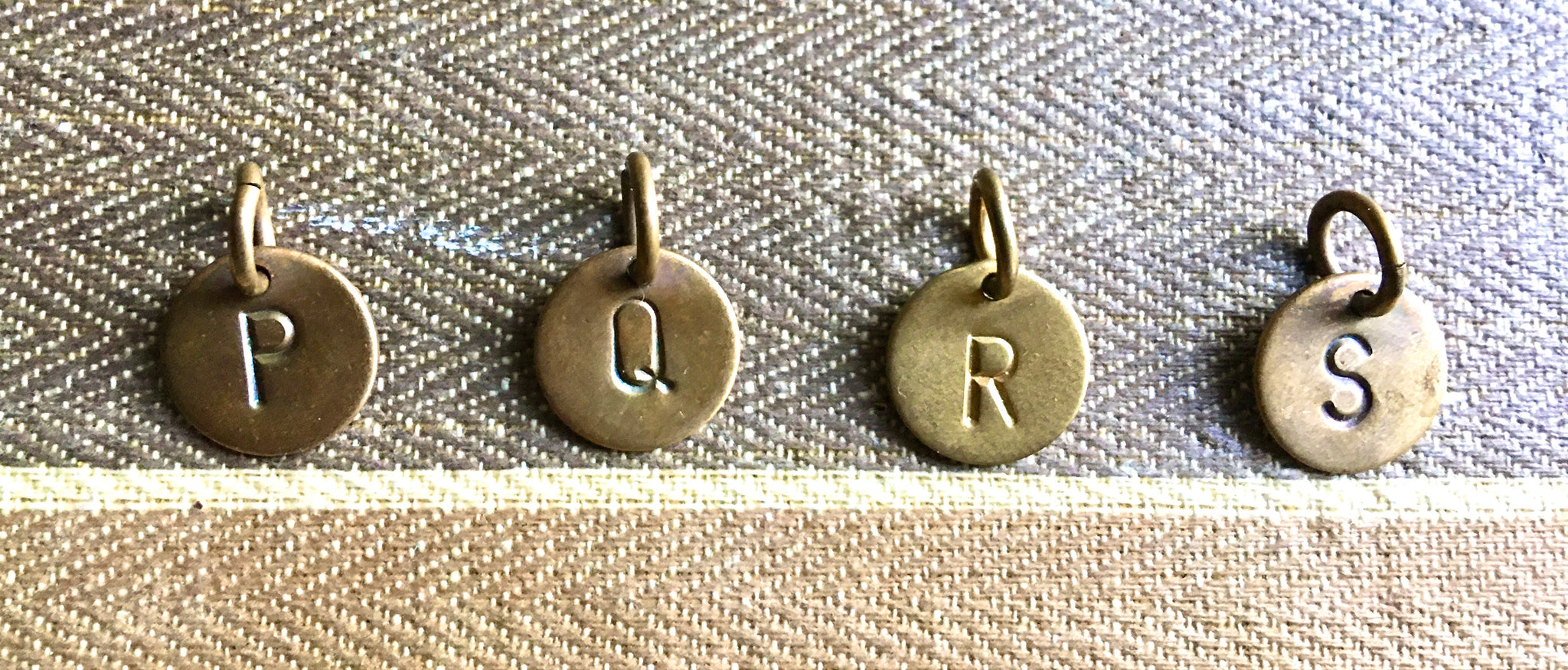 Brass letters P, Q, R, S